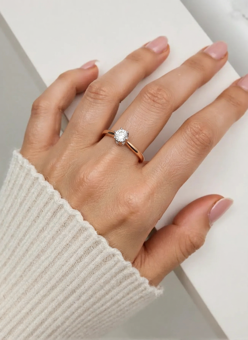 Elegantiškas sužadėtuvių žiedas moters rankoje