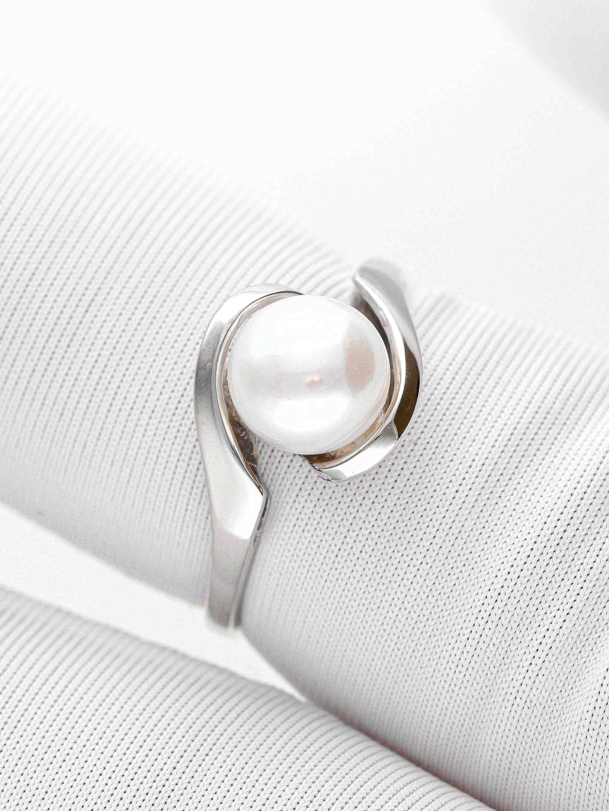 Žiedas su baltu perlu ir moderniu baltu metalo pagrindu