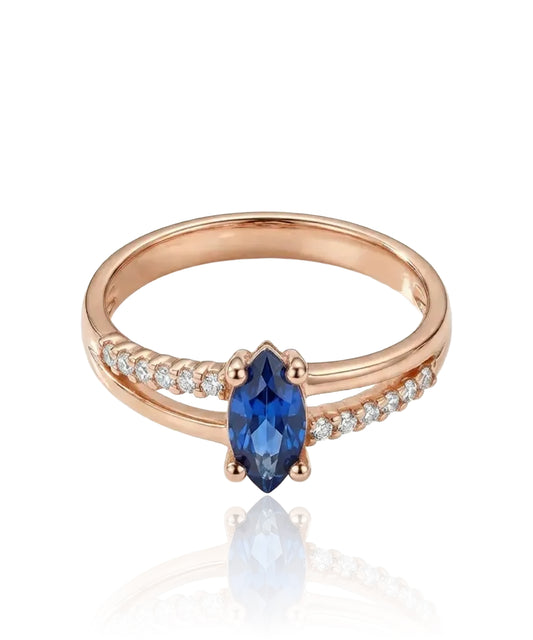 Red gold ring with blue zircon and side holes